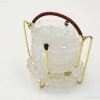 Elegant vintage glass container with burgundy handle, perfect for serving or decorative display.