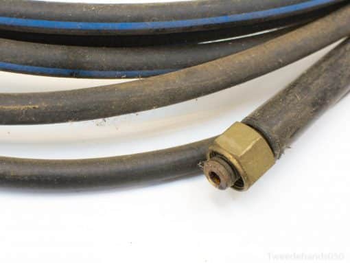 Worn black rubber hoses with blue stripes and brass connector for industrial fluid transport.