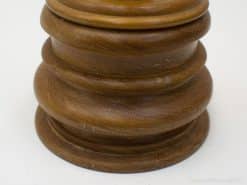 Elegant wooden pedestal with vintage charm, perfect for showcasing candles and decorative accents.