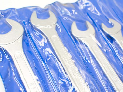 Shiny wrench set in a blue pouch, ideal for mechanics and DIY projects.