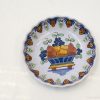 Charming vintage ceramic plate with vibrant fruit basket design for stylish home decor.
