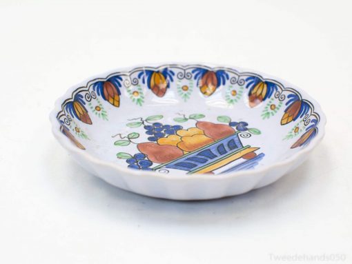 Vibrant handmade ceramic dish with colorful fruit design, ideal for decor and entertaining.
