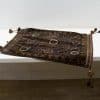Elegant handmade rug with intricate patterns and vibrant tassels in rich earth tones.