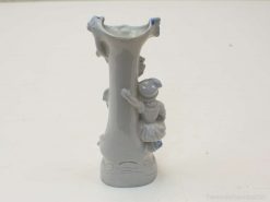 Charming porcelain vase featuring playful child sculptures in soft gray and blue hues.