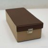Chic vintage brown and beige storage box with metal latch for organized living spaces.