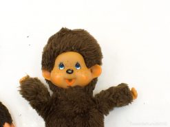 Whimsical vintage plush doll with blue eyes and soft brown fur, ideal for hugging and collecting.