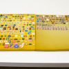 Vibrant vintage pins curated on a yellow backdrop, capturing nostalgia and unique designs.