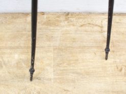 Elegant black metal legs with vintage charm, showcasing distinctive wear and timeless character.