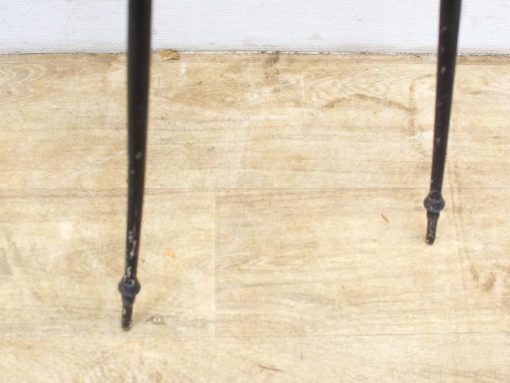 Elegant black metal legs with vintage charm, showcasing distinctive wear and timeless character.