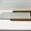 Curved glass panel in dark wood frame, adding sophisticated style to modern interiors.