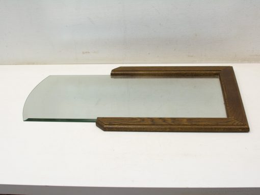 Curved glass panel in dark wood frame, adding sophisticated style to modern interiors.