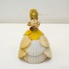 Delicate handcrafted seashell figurine of a woman, perfect for coastal decor and unique gifts.