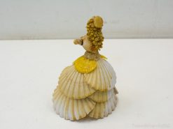 Elegant seashell figurine of a lady in a layered dress, showcasing intricate coastal artistry.
