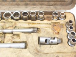 Vintage socket wrench set showcased in a worn toolbox, ideal for repairs and DIY projects.