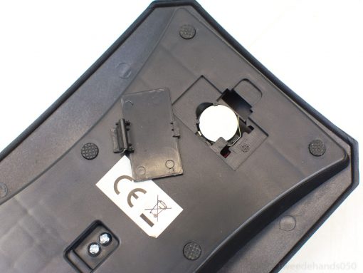 Sleek black kitchen scale with battery compartment and non-slip grips for everyday use.