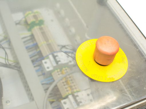Emergency stop button on industrial control panel ensures safety in critical operations.