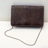 Stylish dark brown crocodile-pattern handbag with adjustable strap for versatile fashion.