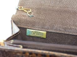 Elegant brown suede wallet by Hispania with gold label and practical zippered compartments.