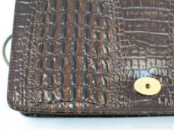 Luxurious brown crocodile leather wallet with gold closure, perfect blend of elegance and practicality.