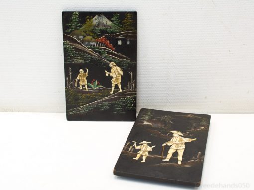 Decorative wooden panels showcasing detailed rural scenes and traditional craftsmanship.