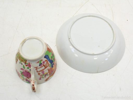 Vintage porcelain tea cup and saucer with colorful floral designs, perfect for elegant dining.