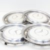 Set of four vintage Mercedes-Benz hubcaps with polished finish and classic three-pointed star logo.