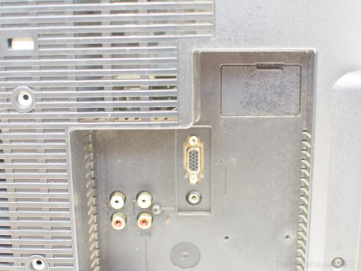 Sony LCD TV rear with RCA and VGA ports, featuring a sleek design and ventilation slots.