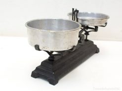 Antique balance scale with shiny pans, ideal for home decor or precise kitchen weighing.