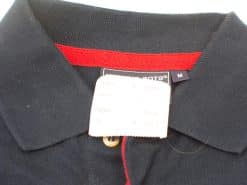 Navy polo shirt with red collar detail, size medium, ideal for casual and smart-casual wear.