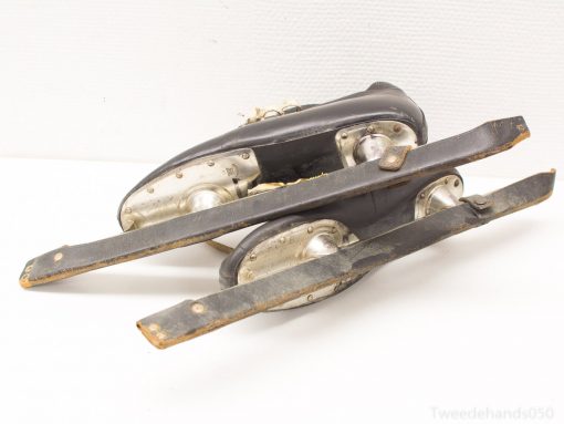 Classic vintage leather ice skates with polished blades, showcasing timeless craftsmanship and nostalgic charm.