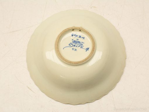 Elegant scalloped porcelain bowl with creamy glaze and blue makers mark for decor or collection.