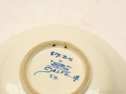 Elegant porcelain dish with blue initials, creamy glaze, ideal for collectors and home decor.