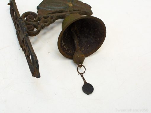 Rustic antique metal bell with decorative bracket, ideal for vintage home decor accents.
