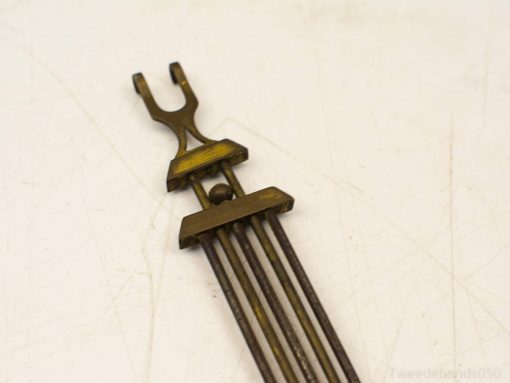 Vintage brass tool with intricate fork design, perfect for decor, collectors, and historical enthusiasts.