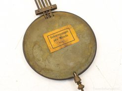 Antique brass oscillation meter, intricately designed with rods, showcasing historic scientific craftsmanship.