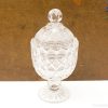 Elegant crystal compote with lid, showcasing exquisite craftsmanship for decorative and functional use.