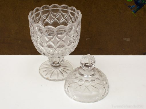 Elegant glass bowl with a decorative lid and diamond pattern, perfect for serving or display.