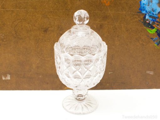Elegant crystal compote with lid, showcasing exquisite craftsmanship for decorative and functional use.