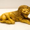 Intricate yellow lion sculpture, showcasing elegance and strength, perfect for decor or collection.