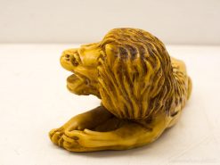 Stunning amber lion sculpture capturing strength and elegance with intricate detailing and dynamic pose.