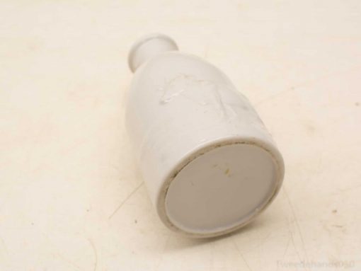 Elegant vintage white ceramic bottle, perfect for decoration and as a collectible piece.