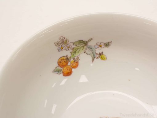 Hand-painted ceramic fruit bowl featuring vibrant oranges and delicate flowers, ideal for décor or dining.