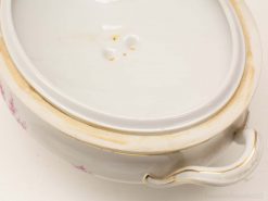 Vintage porcelain serving dish with gold trim and delicate floral patterns, perfect for elegant dining.