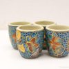 Vibrantly decorated handmade ceramic flower cups, perfect for decor or unique gifts.