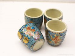 Colorful vintage ceramic cups with floral designs and gold accents for elegant serving.
