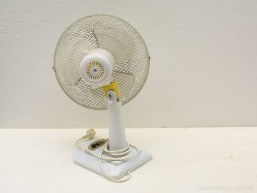 Charming vintage white desk fan with adjustable angle, perfect for stylish cooling and nostalgic decor.
