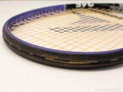 Vintage black and purple tennis racket showcasing wear, character, and a love for the game.