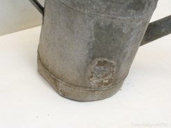 Charming vintage metal watering can, ideal for gardening and rustic home decor.