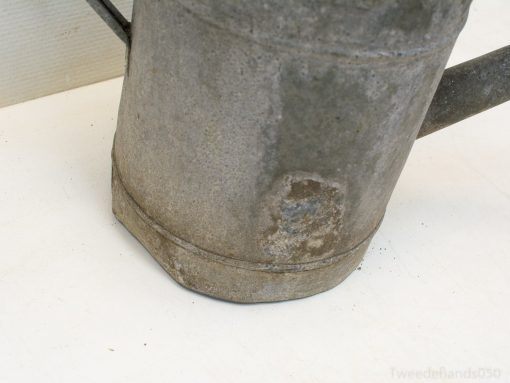 Charming vintage metal watering can, ideal for gardening and rustic home decor.