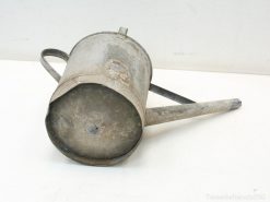 Rustic vintage metal watering can with character, perfect for gardening and home decor.